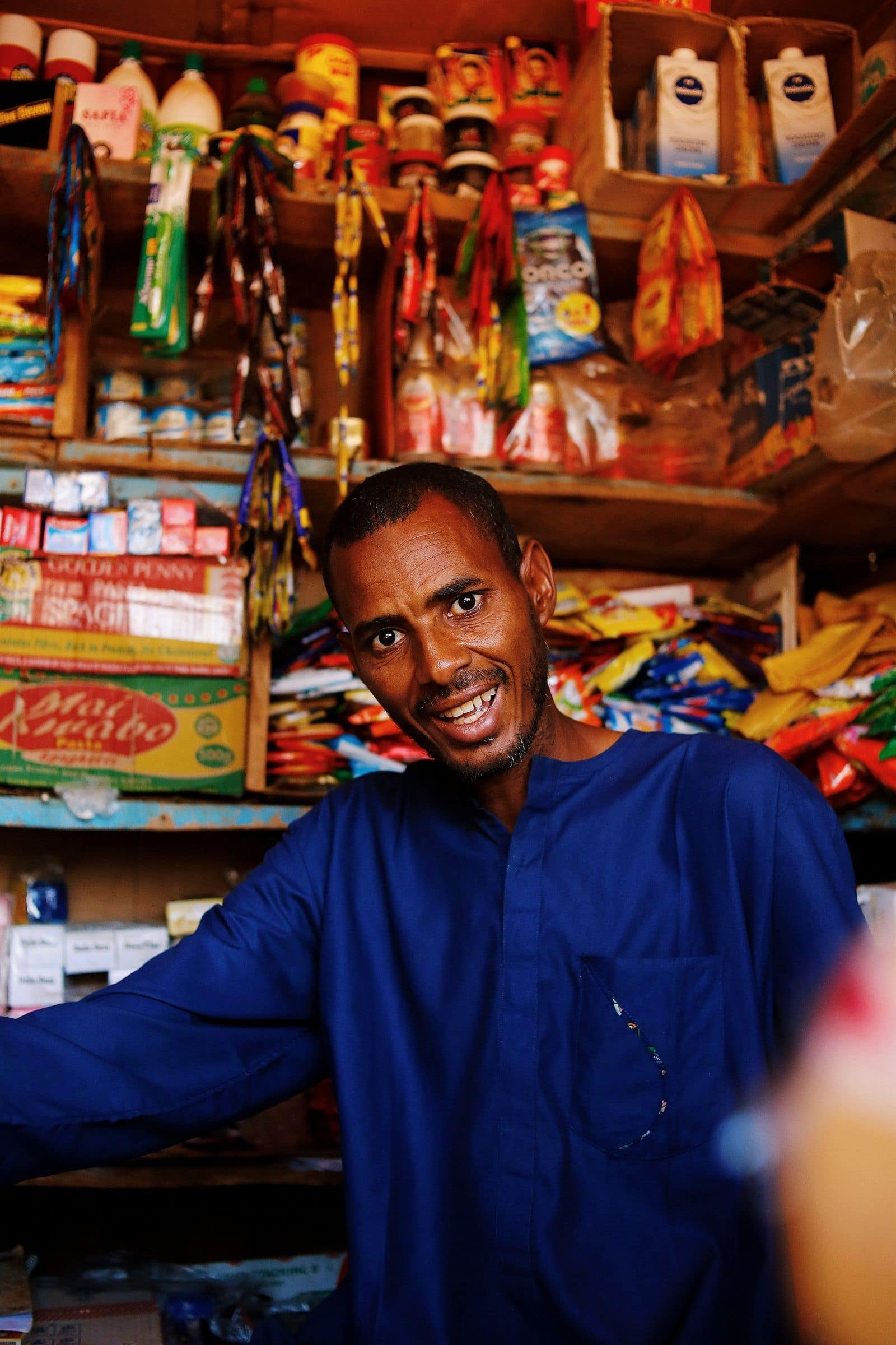 A Pocket Power community hub operator at the counter of a local shop in the FCT